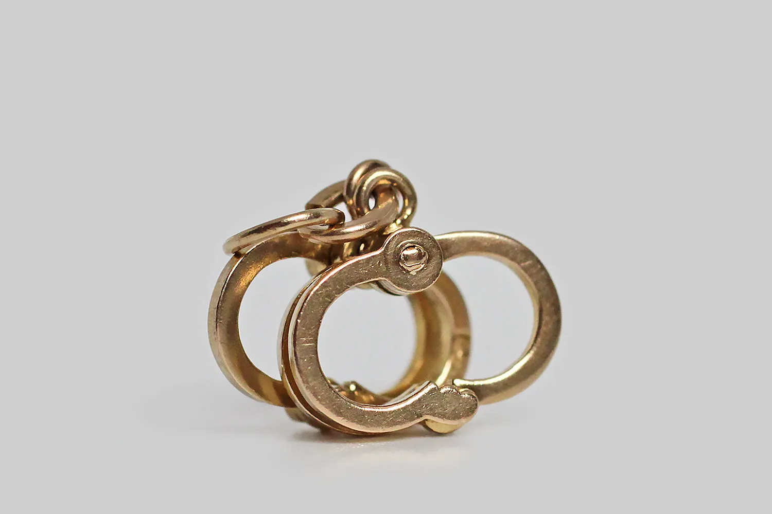 Dainty Mid 20th Century Mechanical Handcuffs Charm in 14k Gold